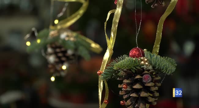 Deux femmes discutent devant une table avec des pommes de pin et décorations de fête dans une serre à Troyes