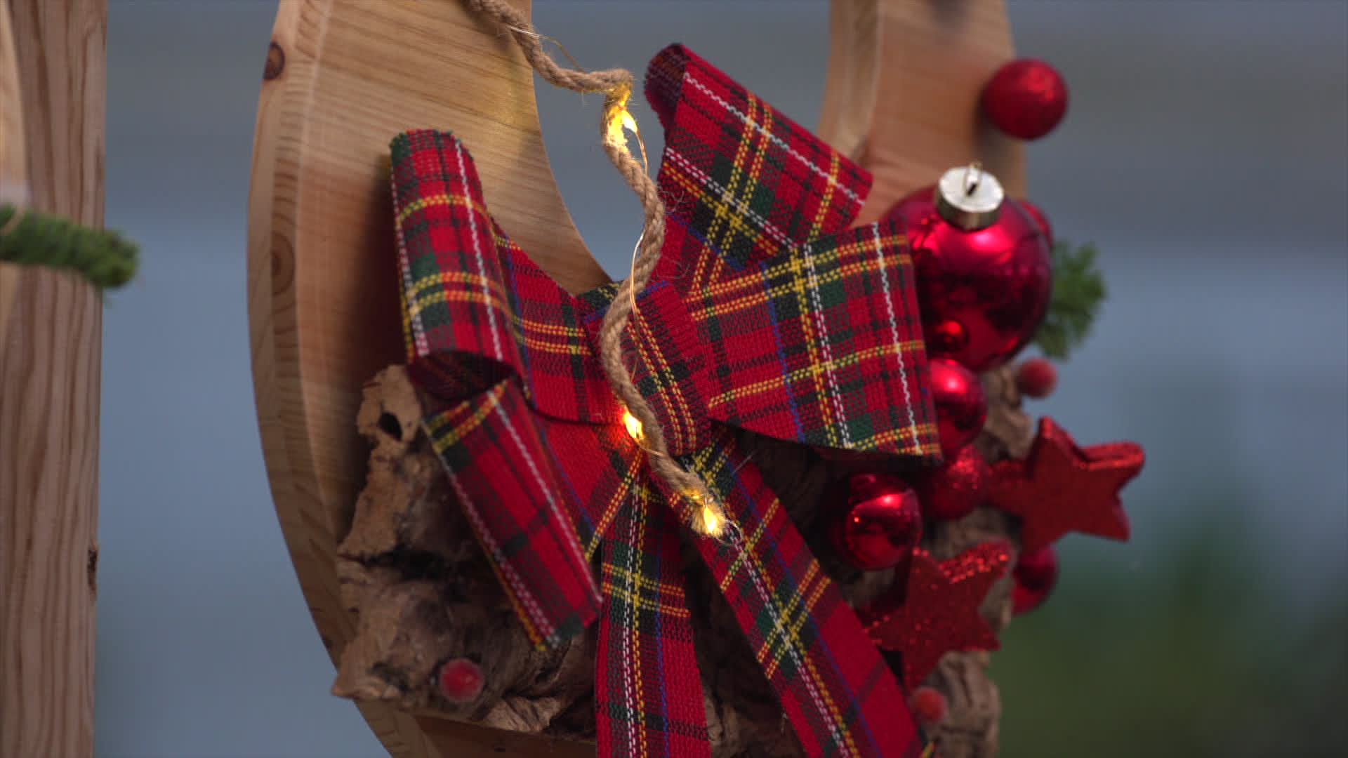 décoration de porte festive avec ruban écossais rouge et boules rouges