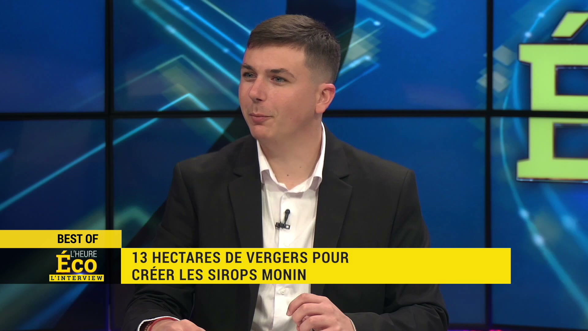Invité en veste noire sur le plateau de L'Heure Éco, bandeau jaune indiquant 13 hectares de vergers pour créer les